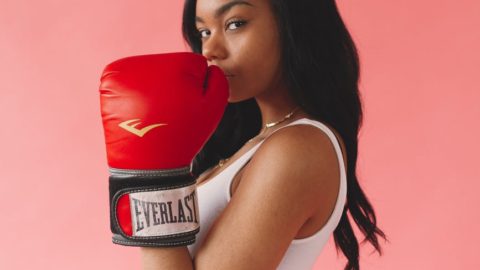 photo of woman wearing red boxing gloves