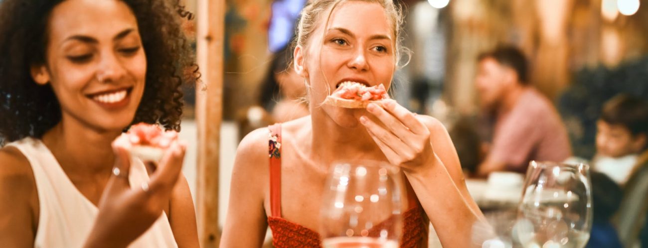 woman eating bruschetta