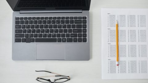 a top view of laptop and test paper on the table